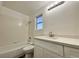 Well-lit bathroom with white tiled shower/tub and modern white vanity at 6063 Peach Orchard Rd, Las Vegas, NV 89142
