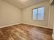 Bedroom featuring wood floors and a window providing natural light at 6063 Peach Orchard Rd, Las Vegas, NV 89142
