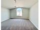 Bright bedroom features vaulted ceilings, soft carpet, and large window at 6063 Peach Orchard Rd, Las Vegas, NV 89142