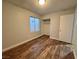 Bedroom featuring wood floors, closet and a window providing natural light at 6063 Peach Orchard Rd, Las Vegas, NV 89142