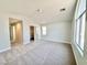 Spacious bedroom featuring soft carpet, generous natural light, and a walk-in closet at 6063 Peach Orchard Rd, Las Vegas, NV 89142