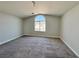 Spacious bedroom with a large arched window and soft, neutral carpeting at 6063 Peach Orchard Rd, Las Vegas, NV 89142