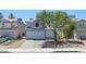 Inviting two-story home with great curb appeal, a manicured front yard, and a two-car garage at 6063 Peach Orchard Rd, Las Vegas, NV 89142