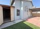 Exterior view of the home with storage shed, artificial turf, and awning at 6063 Peach Orchard Rd, Las Vegas, NV 89142