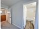 Hallway view with wood floors, a cabinet, and bathroom visible through the doorway at 6063 Peach Orchard Rd, Las Vegas, NV 89142