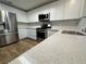 Updated kitchen featuring stainless steel appliances, modern white cabinetry, and quartz countertops at 6063 Peach Orchard Rd, Las Vegas, NV 89142