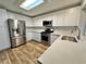 Updated kitchen featuring stainless steel appliances, modern white cabinetry, quartz countertops, and a skylight at 6063 Peach Orchard Rd, Las Vegas, NV 89142