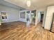 Bright living room showcasing vaulted ceilings, wood-look flooring, and an open floorplan with staircase at 6063 Peach Orchard Rd, Las Vegas, NV 89142