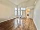 Bright living room showcasing vaulted ceilings, wood-look flooring, and a white front door with sidelight windows at 6063 Peach Orchard Rd, Las Vegas, NV 89142