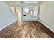 Bright living room showcasing vaulted ceilings, wood-look flooring, and an open floorplan with fireplace at 6063 Peach Orchard Rd, Las Vegas, NV 89142