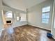 Bright living room showcasing vaulted ceilings, wood-look flooring, and an open floorplan with fireplace at 6063 Peach Orchard Rd, Las Vegas, NV 89142