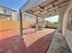 Relaxing covered patio with brick flooring, adjacent to a storage shed, and backyard with well maintained turf at 6063 Peach Orchard Rd, Las Vegas, NV 89142
