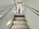 A well lit carpeted staircase at 6063 Peach Orchard Rd, Las Vegas, NV 89142