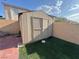 Backyard storage shed is surrounded by a brick privacy wall with low-maintenance artificial turf at 6063 Peach Orchard Rd, Las Vegas, NV 89142