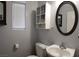 Bathroom with toilet, sink, cabinet, mirror, and window with blinds at 6283 Lapilli Ave, Las Vegas, NV 89139