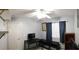 This bedroom features a ceiling fan, window, and desk, offering a functional space at 6283 Lapilli Ave, Las Vegas, NV 89139
