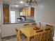 Inviting dining area with natural wood table, cozy seating, and adjacent kitchen space at 6283 Lapilli Ave, Las Vegas, NV 89139