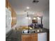 Functional kitchen featuring wood cabinets, granite countertops, and modern appliances at 6283 Lapilli Ave, Las Vegas, NV 89139