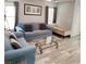Cozy living room with plush seating, neutral tones, and wood-look tile flooring at 6283 Lapilli Ave, Las Vegas, NV 89139