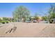 A community playground with play equipment, benches and landscaping at 6283 Lapilli Ave, Las Vegas, NV 89139
