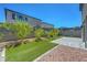 Backyard with artificial turf, a paver patio, and privacy landscaping at 629 Soaring Wings Ave, Las Vegas, NV 89183