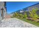 Paver patio with artificial turf, landscaping, and a privacy wall at 629 Soaring Wings Ave, Las Vegas, NV 89183