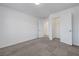 Bedroom featuring neutral carpet and white walls with an open closet space at 629 Soaring Wings Ave, Las Vegas, NV 89183