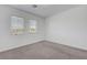 Bright bedroom features neutral carpet, white walls, and two windows allowing natural light at 629 Soaring Wings Ave, Las Vegas, NV 89183