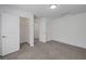 Bedroom featuring neutral carpet, white walls, and an open closet space at 629 Soaring Wings Ave, Las Vegas, NV 89183