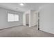 A bright bedroom features neutral walls, carpet, a window, and a closet at 629 Soaring Wings Ave, Las Vegas, NV 89183
