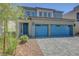 Beautiful two-story home with blue accents, landscaped front yard, and a modern paved driveway at 629 Soaring Wings Ave, Las Vegas, NV 89183