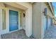 Inviting covered front porch features a modern blue door and minimalist lighting fixtures at 629 Soaring Wings Ave, Las Vegas, NV 89183