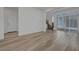 Bright and airy living space with wood-look floors and access to the outdoors through sliding glass doors at 629 Soaring Wings Ave, Las Vegas, NV 89183