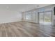 Large living room with wood-look flooring and access to the outdoor space at 629 Soaring Wings Ave, Las Vegas, NV 89183