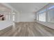 Open living area with wood-look floors and abundant natural light through sliding glass door at 629 Soaring Wings Ave, Las Vegas, NV 89183