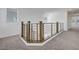Loft area featuring modern railing, neutral carpet, and natural light at 629 Soaring Wings Ave, Las Vegas, NV 89183