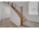 Modern staircase with wood railings and plush carpeting leads to the upper level at 629 Soaring Wings Ave, Las Vegas, NV 89183