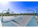 Outdoor basketball court with multiple hoops, surrounded by green landscaping and mountain views at 6909 Toll Mountain St, North Las Vegas, NV 89086