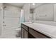 Bright bathroom featuring a shower and tub combo with shower curtain and modern vanity at 6909 Toll Mountain St, North Las Vegas, NV 89086