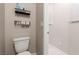 This bathroom is equipped with a toilet, shelves, and a window at 6909 Toll Mountain St, North Las Vegas, NV 89086