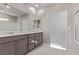 Bathroom featuring double vanity with modern sinks and a large mirror at 6909 Toll Mountain St, North Las Vegas, NV 89086