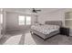 Inviting bedroom featuring soft carpet, natural light, and a comfortable chair for relaxation at 6909 Toll Mountain St, North Las Vegas, NV 89086
