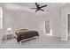 Bright bedroom with a ceiling fan, soft carpeting, and an ensuite bathroom offering both comfort and convenience at 6909 Toll Mountain St, North Las Vegas, NV 89086