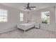 Bright bedroom with ample natural light, a ceiling fan and carpet flooring at 6909 Toll Mountain St, North Las Vegas, NV 89086
