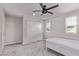 Bright bedroom featuring a ceiling fan, large closet, and natural light at 6909 Toll Mountain St, North Las Vegas, NV 89086
