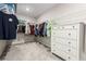 Well-organized walk-in closet with ample shelving, clothing racks, and a dresser for efficient storage at 6909 Toll Mountain St, North Las Vegas, NV 89086