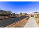 Gated community entrance with stone accents and well-maintained landscaping, promoting security and curb appeal at 6909 Toll Mountain St, North Las Vegas, NV 89086