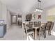 Open-concept dining area features modern lighting and ample space, seamlessly flowing into the kitchen and living area at 6909 Toll Mountain St, North Las Vegas, NV 89086