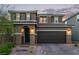 Charming two-story home with a two-car garage, featuring a well-maintained yard and inviting curb appeal at 6909 Toll Mountain St, North Las Vegas, NV 89086