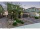 Charming two-story home featuring a beautifully bricked driveway and landscaped front yard at 6909 Toll Mountain St, North Las Vegas, NV 89086